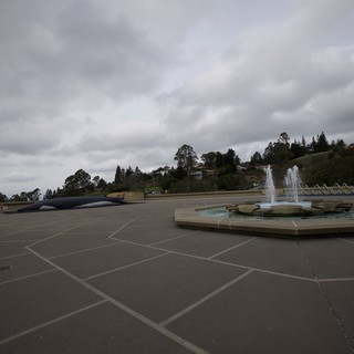 Cloudy Plaza with Fountain and Modernist Sculpture