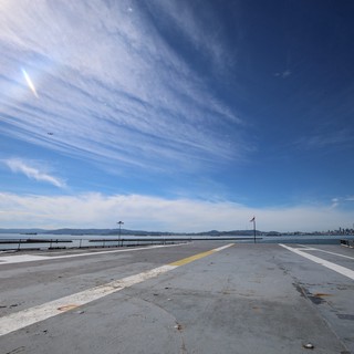 Wide Aircraft Carrier Flight Deck with Distant Skyline