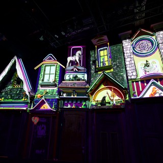 Whimsical Neon-Lit Miniature Village Display at Night