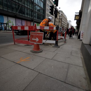 Construction Worker on London Street During Roadwork