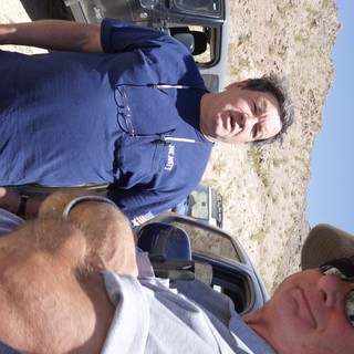Two Men Conversing in Arid Desert Terrain