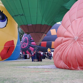 Ground Crew Prepares Colorful Balloons at Classic Festival