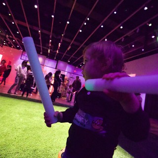Child with Light Saber at Baby Rave Event