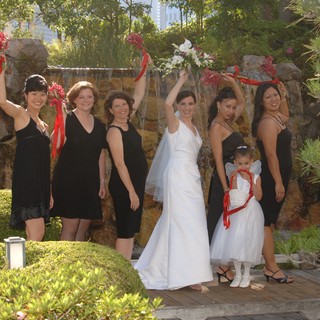 Bridal Party Celebrates with Bouquets at Garden Waterfall