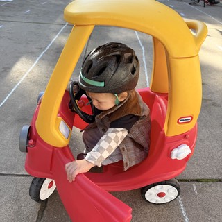 Young Child in Little Tikes Car at Community Event