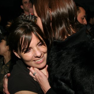 Warm Embrace at a Crowded Nighttime Gathering