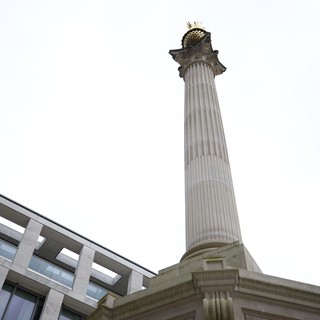 Ornate Column Monument Against Overcast London Sky