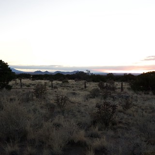 Twilight Over Desert Grassland and Distant Mountains