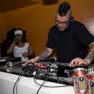 Dubstep DJ mixing tunes wearing signature tattoos