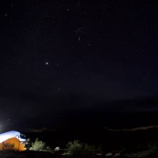 Mountain Tent Illuminated Under Starry Sky