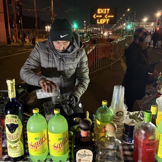 Street Bartender Mixing Drinks at Night Event