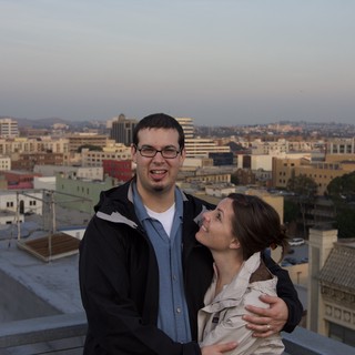 Couple Embracing on Urban Rooftop at Dusk