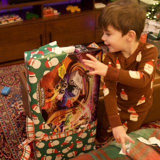 Christmas Morning Joy: Young Boy Opening Presents