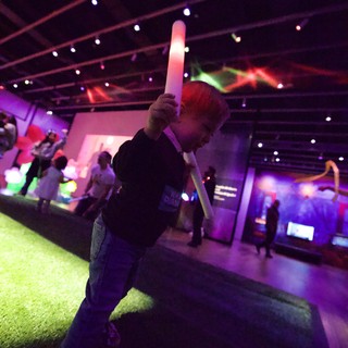 Child with LED Sword at Baby Rave Event