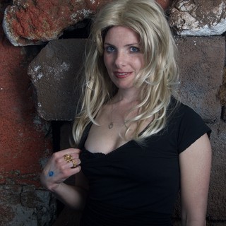 Blonde Halloween Costume Portrait Against Stone Wall