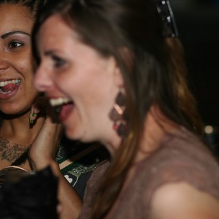 Two Women Laughing Together at Nighttime Event