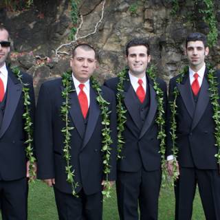 Four Men in Suits Pose Before Rock Wall