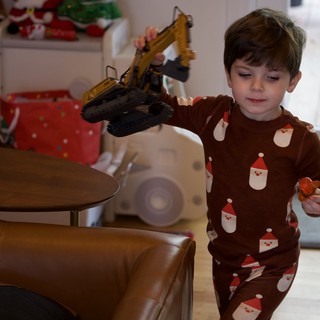 Boy Playing with Toy Excavator on Christmas Eve