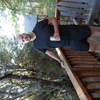 Man Enjoying Morning Coffee on Wooden Deck