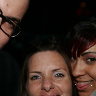 Three Friends Posing Close Together at Night