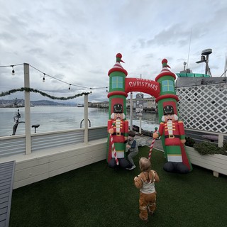 Children Exploring Christmas Nutcracker Inflatables at Waterfront