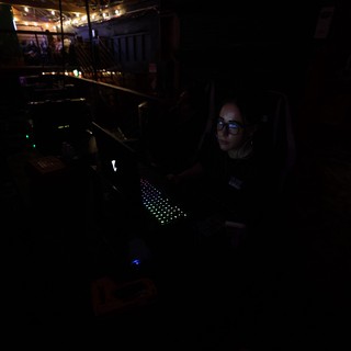 Lighting Technician Working in Darkened Concert Booth