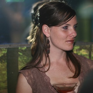 Elegant Woman at Evening Social Gathering with Cocktail