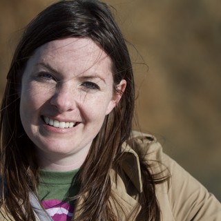 Smiling Woman Outdoors on a Sunny Winter Day