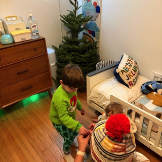 Brothers Decorating Christmas Tree in Children's Bedroom