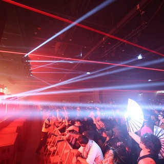 Laser Light Storm Over Pulsing Festival Crowd