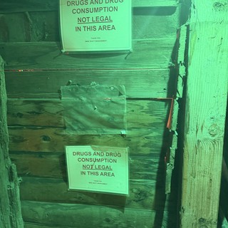 Drug Warning Signs in Green-Lit Mine Alley