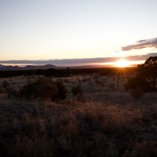Desert Sunset Over Distant Mountain Range