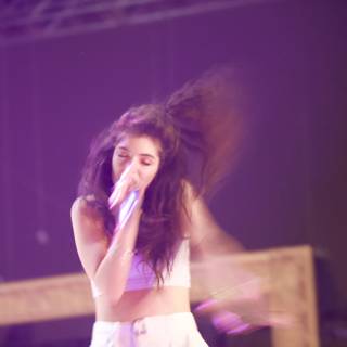 Lorde Takes the Stage with Microphone in Hand