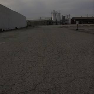 Desolate Lot with Factory in the Distance