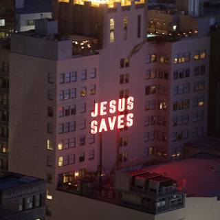 City Building with Jesus Saves Sign at Night