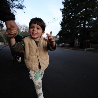 Joyful Child on Evening Walk with Parent