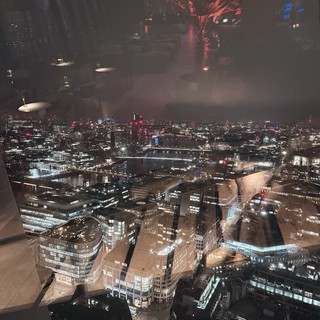 Reflective Night View Over London's Illuminated Cityscape