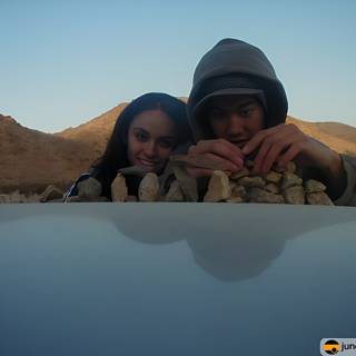Sitting on the Hood of a Car in the Desert