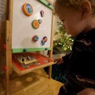 Young Child Playing with Educational Toy on Christmas