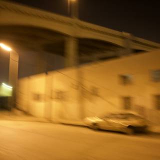 Blurred car travels down dimly lit road
