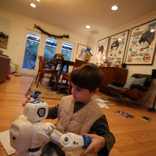 Child Playing with Robot Toy in Cozy Living Room