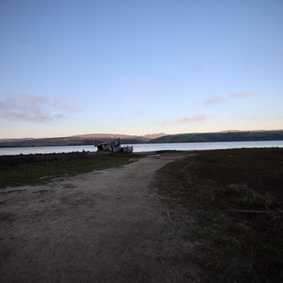 Shipwreck at Twilight on Coastal Bay