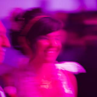Blur of a Purple-Clad Woman Dancing in the Dark