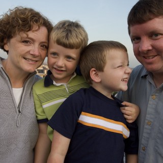 Happy Family Portrait at Sunset Overlooking the City