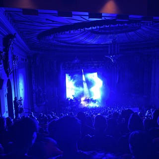 Concert Performance in Historic Ornate Theater with Blue Stage Lighting