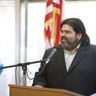 Man with Long Hair and Beard Delivering a Speech