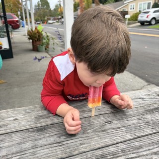 Child Enjoying a Popsicle on Autumn Day