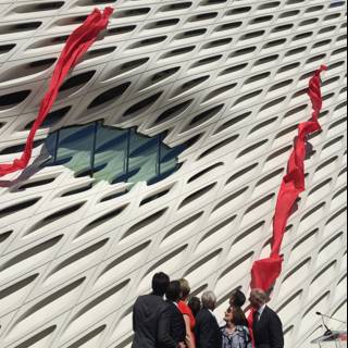 Group of People with Red Flags in Front of The Broad
