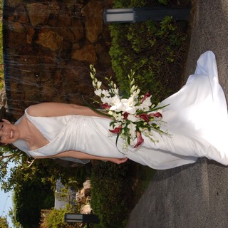 Radiant Bride Poses Before Stone Waterfall Feature