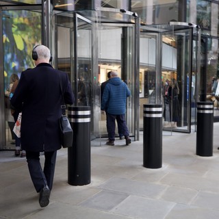 Urban Professionals Navigate Modern Glass Revolving Doors